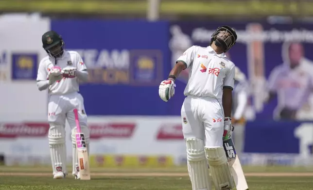 Bangladesh's captain Najmul Hossain Shanto, right, leaves the ground after losing his wicket as Mushfiqur Rahim watches during the second day of the first cricket test match between Sri Lanka and Bangladesh in Galle, Sri Lanka, Wednesday, June 18, 2025. (AP Photo/Eranga Jayawardena)