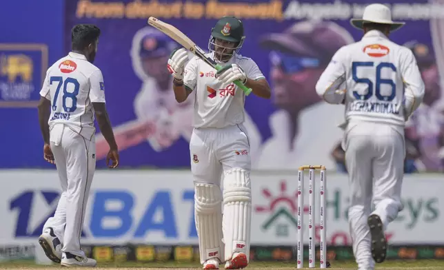 Bangladesh's captain Najmul Hossain Shanto signals for a decision review after he was given out during the second day of the first cricket test match between Sri Lanka and Bangladesh in Galle, Sri Lanka, Wednesday, June 18, 2025. (AP Photo/Eranga Jayawardena)