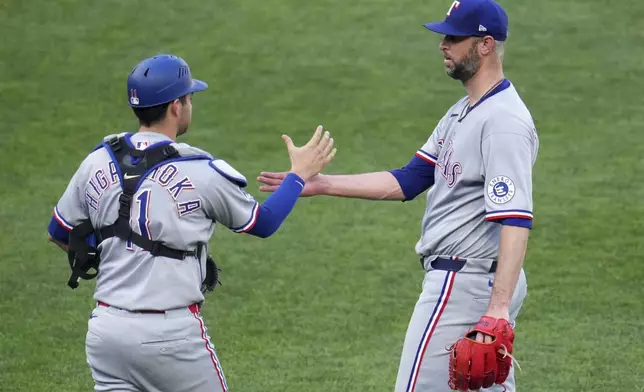 Texas Rangers pitcher Chris Martin, right, celebrates with catcher Kyle Higashioka after getting the final out of a baseball game against the Pittsburgh Pirates in Pittsburgh, Saturday, June 21, 2025. (AP Photo/Gene J. Puskar)