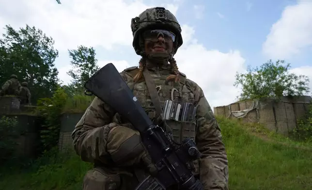 20-year-old conscript Katrine poses for a photo during final exercises at a training area close to Royal Danish Army’s barracks in Hovelte, 25 kilometres north of Copenhagen, Denmark, Wednesday, June 11, 2025. (AP Photo/James Brooks)
