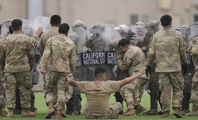 Members of the California National Guard conduct exercises after being deployed to the Los Angeles protests Wednesday, June 11, 2025, in Los Alamitos, Calif. (AP Photo/Jae C. Hong)