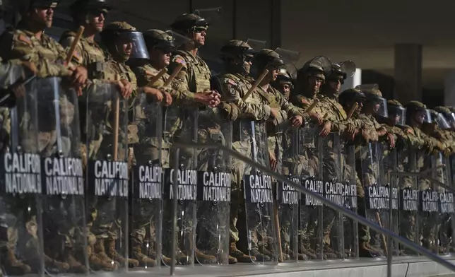 California National Guard are positioned at the Federal Building on Tuesday, June 10, 2025, in downtown Los Angeles. (AP Photo/Eric Thayer)
