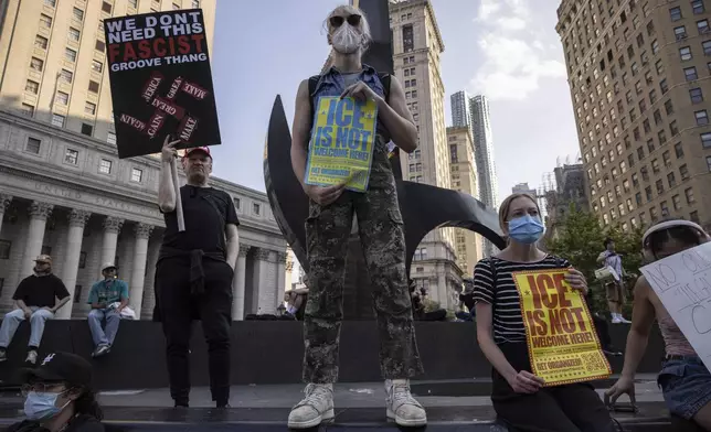 Demonstrators hold signs and chant during a protest against deportation by Immigration and Customs Enforcement in New York, Wednesday, June 11, 2025. (AP Photo/Yuki Iwamura)