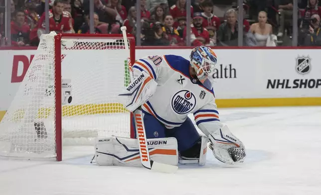 Edmonton Oilers goaltender Calvin Pickard (30) grabs a shot on goal during the second period of Game 4 of the NHL hockey Stanley Cup Final against the Florida Panthers, Thursday, June 12, 2025, in Sunrise, Fla. (AP Photo/Lynne Sladky)