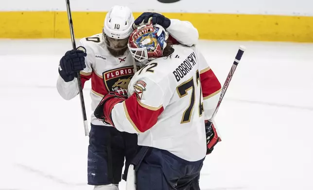 Florida Panthers' A.J. Greer (10) and Sergei Bobrovsky (72) celebrate after their win over the Edmonton Oilers in Game 5 of the NHL hockey Stanley Cup Final in Edmonton, Alberta, Saturday, June 14, 2025. ( Jason Franson/The Canadian Press via AP)