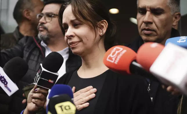 Maria Claudia Tarazona, the wife of Colombian Senator Miguel Uribe Turbay who was shot at a political rally, talks to the press outside the clinic where he is being treated, in Bogota, Colombia, Sunday, June 8, 2025. (AP Photo/Ivan Valencia)