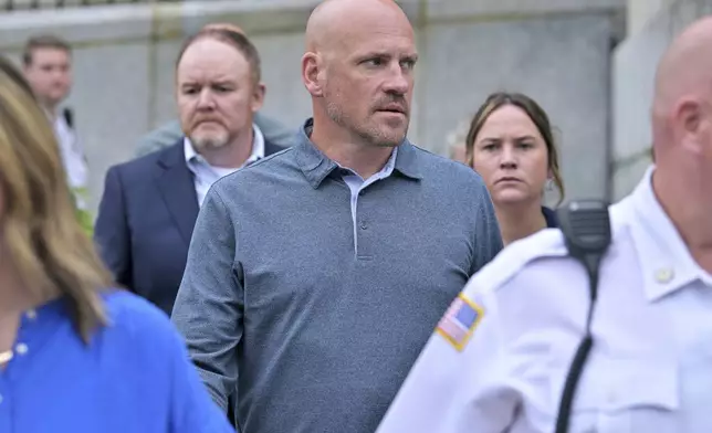 Paul O'Keefe, brother of John O'Keefe, looks toward Karen Read as they leave the courthouse at the start of the third day of jury deliberations in Read's trial at Norfolk Superior Court, Wednesday, June 18, 2025, in Dedham, Mass. (AP Photo/Josh Reynolds)