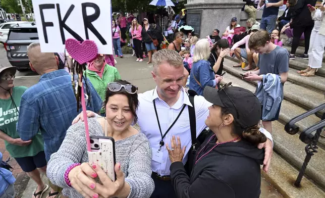 Blogger Aidan Kearney, center, meets with fans and Karen Read supporters, from left, Linda Allen of Rockland, MA, and Shannon LoPorto of Weymouth, MA, outside the Dedham, Mass. courthouse on the third day of jury deliberations in Read's trial at Norfolk Superior Court, Wednesday, June 18, 2025, in Dedham, Mass. (AP Photo/Josh Reynolds)