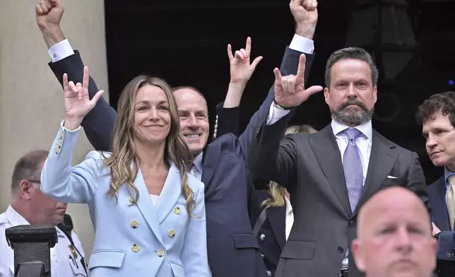 Karen Read gestures to supporters after she was found not guilty of second-degree murder on Wednesday, June 18, 2025, in Dedham, Mass. (AP Photo/Josh Reynolds)