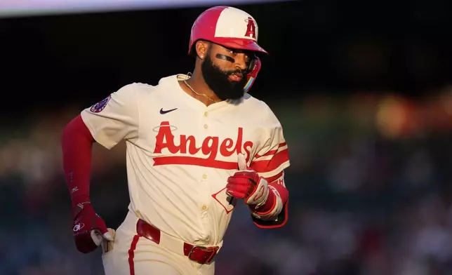 Los Angeles Angels' Jo Adell rounds third after hitting a solo home run during the second inning of a baseball game against the Seattle Mariners, Saturday, June 7, 2025, in Anaheim, Calif. (AP Photo/Mark J. Terrill)