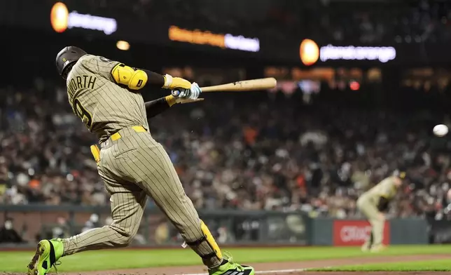 San Diego Padres' Jake Cronenworth hits an RBI single during the 10th inning of a baseball game against the San Francisco Giants, Tuesday, June 3, 2025, in San Francisco. (AP Photo/Godofredo A. Vásquez)