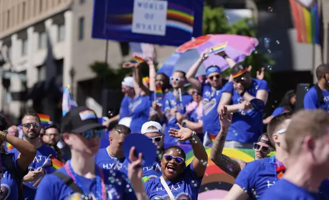 Participants around the World of Hyatt float march during the World Pride parade, Saturday, June 7, 2025, in Washington. (AP Photo/Mark Schiefelbein)