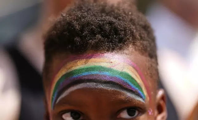 A child watches the World Pride parade, Saturday, June 7, 2025, in Washington. (AP Photo/Julia Demaree Nikhinson)
