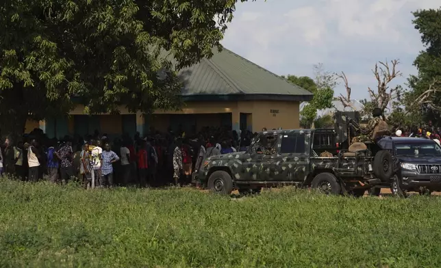 Soldiers stand guard prior to a visit from government officials following an attack by gunmen in Yelewata community north-central Nigeria, Monday, June 16, 2025. (AP Photo)