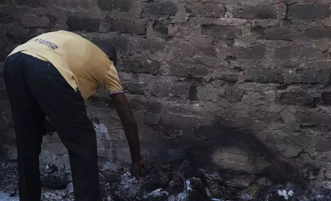 A man looks at a burned house following an attack by gunmen in Yelewata community north-central Nigeria, Monday, June 16, 2025. (AP Photo)