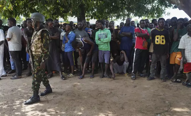 A soldier stands guard prior to the government officials visit following an attack by gunmen in Yelewata community north-central Nigeria, Monday, June 16, 2025. (AP Photo)