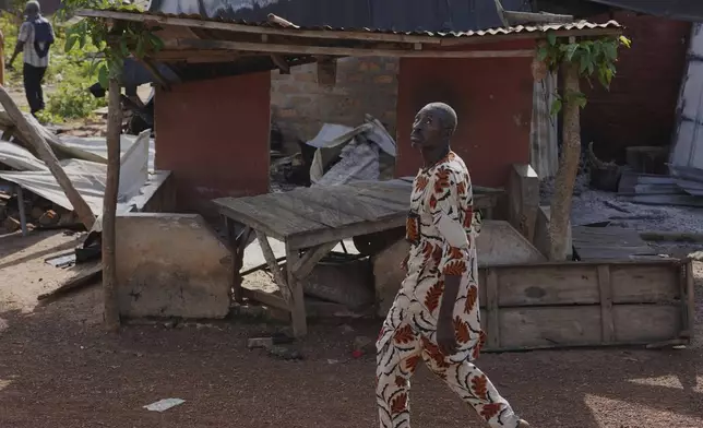A man walks past a damaged house following an attack by gunmen in Yelewata community north-central Nigeria, Monday, June 16, 2025. (AP Photo)