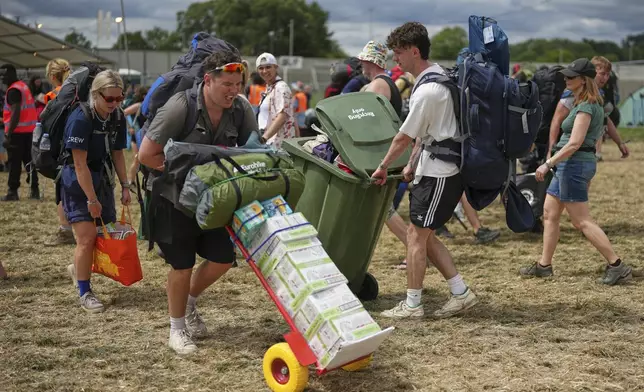 Festival goers arrive at the Glastonbury Festival in Worthy Farm, Somerset, England, Wednesday, June 25, 2025. (Scott A Garfitt/Invision/AP)