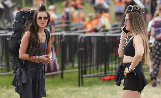 Festival goers arrive at the Glastonbury Festival in Worthy Farm, Somerset, England, Wednesday, June 25, 2025. (Scott A Garfitt/Invision/AP)