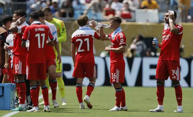 Benfica players take a cooling break during the Club World Cup Group C soccer match between Benfica and Bayern Munich in Charlotte, N.C., Tuesday, June 24, 2025. (AP Photo/Nell Redmond)