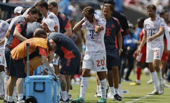 Bayern players take a cooling break during the Club World Cup Group C soccer match between Benfica and Bayern Munich in Charlotte, N.C., Tuesday, June 24, 2025. (AP Photo/Nell Redmond)