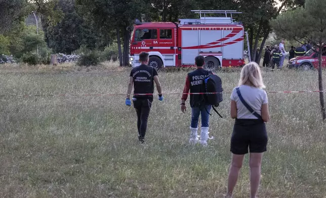 A firefighter truck and forensic police work at the site of the discovery of the body of an infant and the infant’s mother, in Rome’s Villa Pamphili park, Saturday, June 7, 2025. (Francesco Benvenuti/LaPresse via AP)