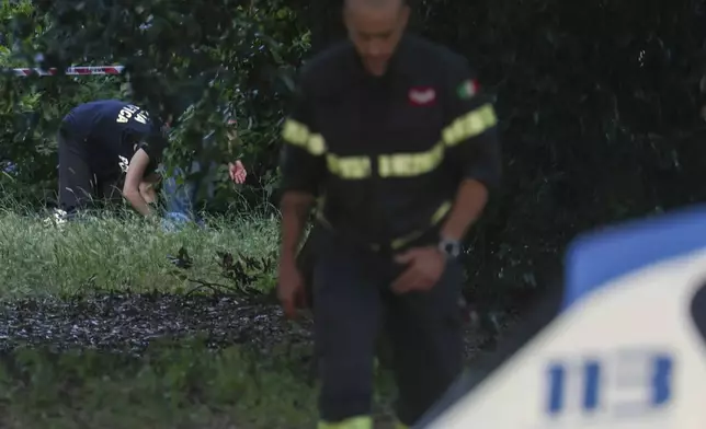 Forensic police working at the site of the discovery of the body of an infant and the infant’s mother, in Rome’s Villa Pamphili park, Saturday, June 7, 2025. (Francesco Benvenuti/LaPresse via AP)