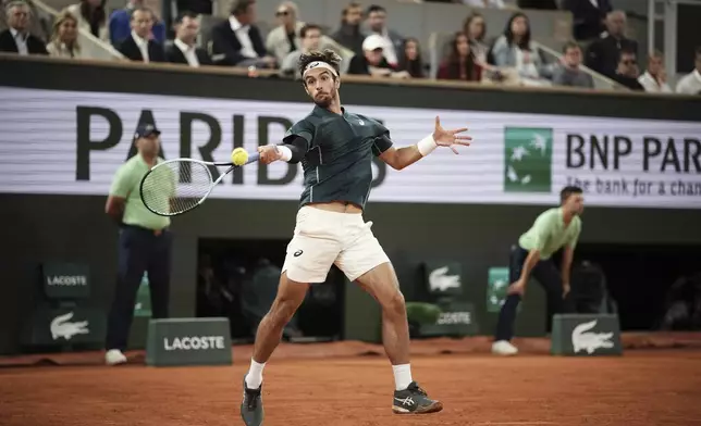 Italy's Lorenzo Musetti plays a shot against Spain's Carlos Alcaraz during their semifinal match of the French Tennis Open at the Roland-Garros stadium in Paris, Friday, June 6, 2025. (AP Photo/Christophe Ena)