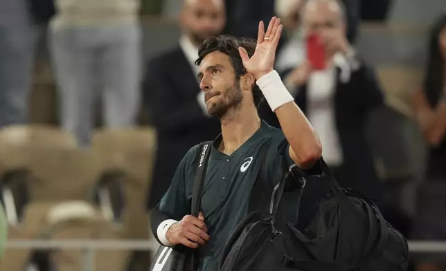 Italy's Lorenzo Musetti reacts as he leaves after the semifinal match of the French Tennis Open against Spain's Carlos Alcaraz at the Roland-Garros stadium in Paris, Friday, June 6, 2025. (AP Photo/Christophe Ena)