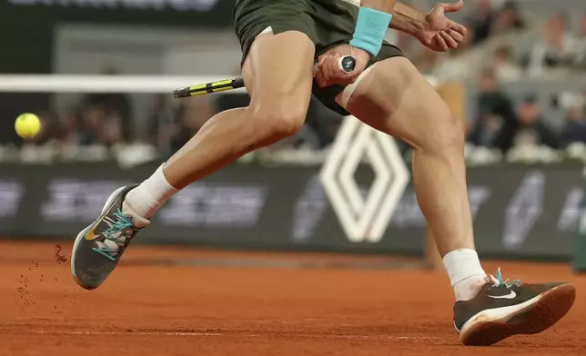 Spain's Carlos Alcaraz plays a shot against Italy's Lorenzo Musetti during their semifinal match of the French Tennis Open at the Roland-Garros stadium in Paris, Friday, June 6, 2025. (AP Photo/Aurelien Morissard)
