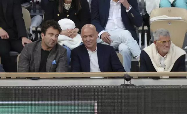 Former tennis star Andre Agassi, centre, watches the semifinal match of the French Tennis Open between Italy's Jannik Sinner and Serbia's Novak Djokovic at the Roland-Garros stadium in Paris, Friday, June 6, 2025. (AP Photo/Aurelien Morissard)