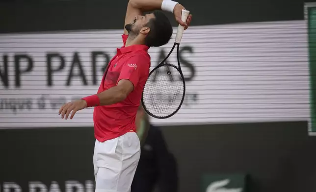 Serbia's Novak Djokovic reacts as he plays against Italy's Jannik Sinner during their semifinal match of the French Tennis Open at the Roland-Garros stadium in Paris, Friday, June 6, 2025. (AP Photo/Christophe Ena)