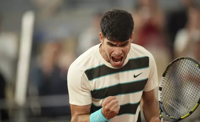 Spain's Carlos Alcaraz reacts as he plays against Italy's Lorenzo Musetti during their semifinal match of the French Tennis Open at the Roland-Garros stadium in Paris, Friday, June 6, 2025. (AP Photo/Christophe Ena)