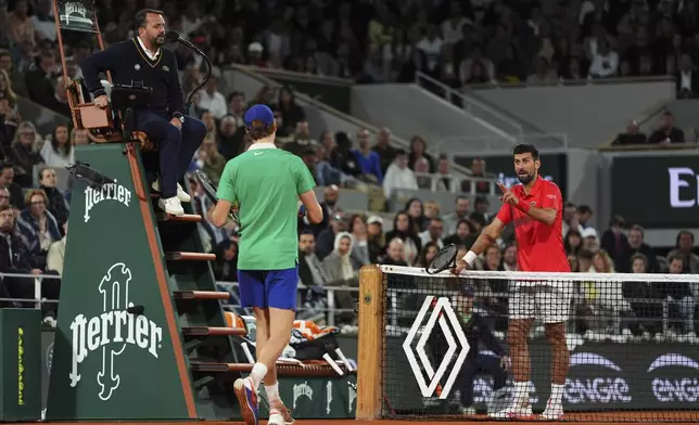 Serbia's Novak Djokovic, right, and Italy's Jannik Sinner talk during their semifinal match of the French Tennis Open at the Roland-Garros stadium in Paris, Friday, June 6, 2025. (AP Photo/Lindsey Wasson)