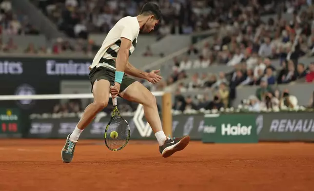 Spain's Carlos Alcaraz plays a shot against Italy's Lorenzo Musetti during their semifinal match of the French Tennis Open at the Roland-Garros stadium in Paris, Friday, June 6, 2025. (AP Photo/Aurelien Morissard)