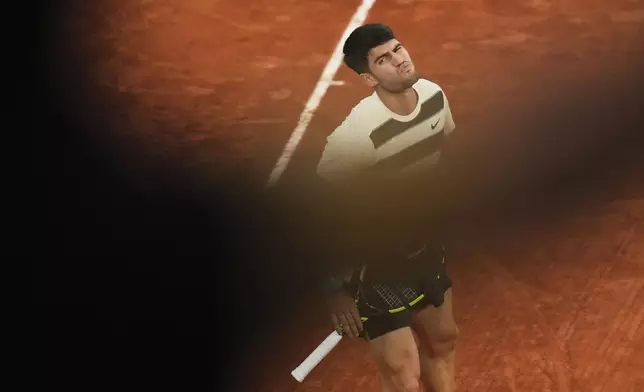 Spain's Carlos Alcaraz reacts as he plays against Italy's Lorenzo Musetti during their semifinal match of the French Tennis Open at the Roland-Garros stadium in Paris, Friday, June 6, 2025. (AP Photo/Thibault Camus)