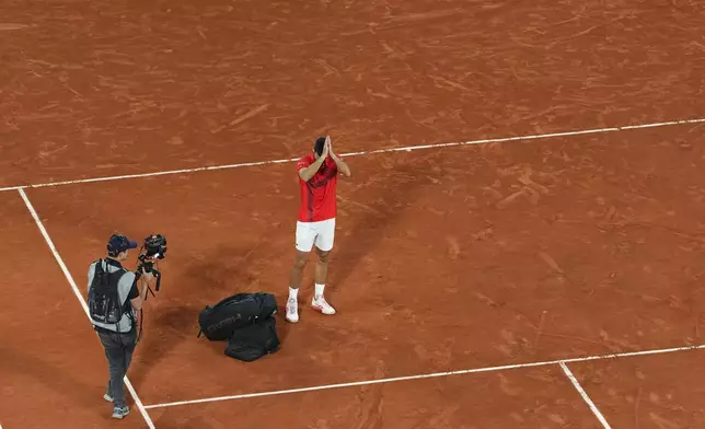 Serbia's Novak Djokovic gestures as he leaves the semifinal match of the French Tennis Open against Italy's Jannik Sinner at the Roland-Garros stadium in Paris, Friday, June 6, 2025. (AP Photo/Lindsey Wasson)