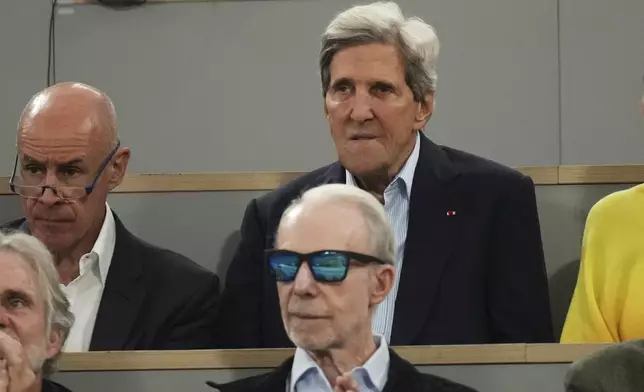 U.S. former Secretary of State John Kerry, centre top, watches the semifinal match of the French Tennis Open between Italy's Lorenzo Musetti and Spain's Carlos Alcaraz at the Roland-Garros stadium in Paris, Friday, June 6, 2025. (AP Photo/Christophe Ena)