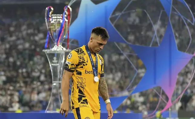 Inter Milan's Lautaro Martinez walks in dejection at the end of the Champions League final soccer match between Paris Saint-Germain and Inter Milan at the Allianz Arena in Munich, Germany, Saturday, May 31, 2025. (AP Photo/Martin Meissner)