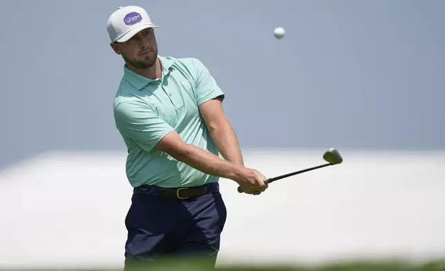 Alistair Docherty chips onto the third hole during a practice round ahead of the U.S. Open golf tournament at Oakmont Country Club Wednesday, June 11, 2025, in Oakmont, Pa. (AP Photo/Charlie Riedel)