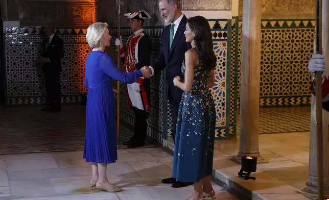 Spain's King Felipe VI and Queen Letizia greet European Commission President Ursula von der Leyen before a gala dinner on the eve of the U.N. financing for development conference in Seville, Spain, Sunday, June 29, 2025. (Mariscal/Pool Photo via AP)
