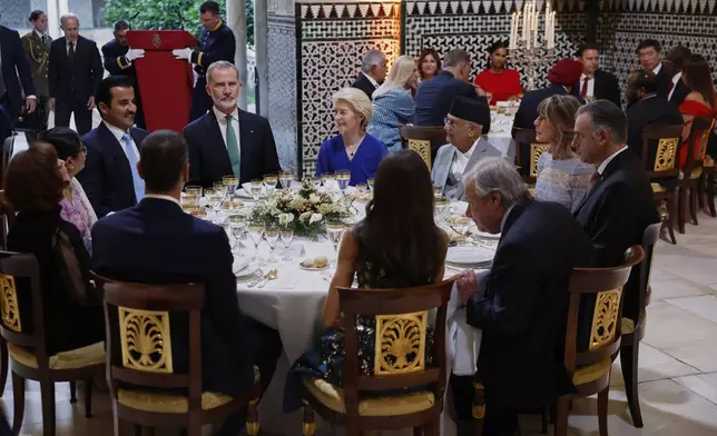 Spain's King Felipe VI, top 2nd left, sits with Qatar's Emir Sheikh Tamim bin Hamad Al Thani, top left, European Commission President Ursula von der Leyen, top 3rd left, Nepal Prime Minister Khadga Prasad Oli, top, 4th left and Antonio Guterres, Secretary-General of the United Nations, lower right, during a gala dinner on the eve of the U.N. financing for development conference in Seville, Spain, Sunday, June 29, 2025. (Chema Moya/Pool Photo via AP)