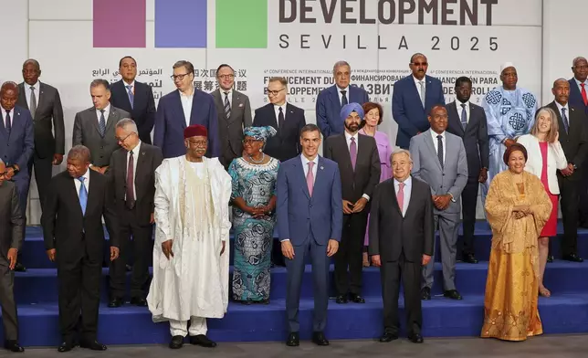 Spain's Prime Minister Pedro Sanchez, center, next to United Nations Secretary-General Antonio Guterres, pose for a photo with nation leaders and representatives, at the start of the four-day Financing for Development meeting, in Seville, Spain, Monday, June 30, 2025. (AP Photo/Jose Angel Garcia)