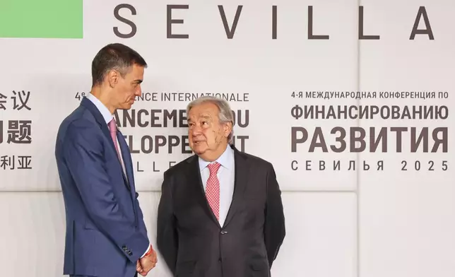 Spain's Prime Minister Pedro Sanchez, left, speaks with Antonio Guterres, Secretary-General of the United Nations, during the four-day Financing for Development meeting in the southern city of Seville, Spain, Monday, June 30, 2025. (AP Photo/Jose Angel Garcia)