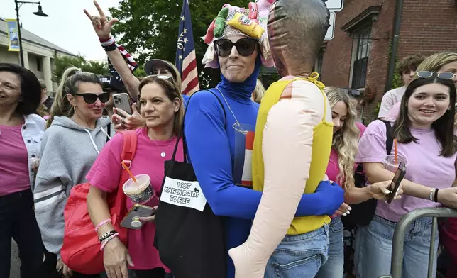 A costumed Karen Read supporter who declined to be identified, center, gathered with fellow supporters waiting for Read to arrive at the Dedham, Mass. courthouse, for closing arguments of her trial at Norfolk Superior Court, Friday, June 13, 2025, in Dedham, Mass. (AP Photo/Josh Reynolds)