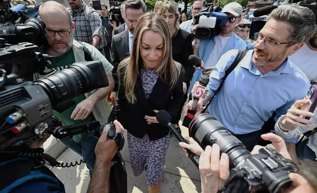 Karen Read, is surrounded by reporters as she and her legal team leave the Dedham, Mass. courthouse, after the judge issued instructions to the jury in Read's trial at Norfolk Superior Court, Friday, June 13, 2025, in Dedham, Mass. (AP Photo/Josh Reynolds)