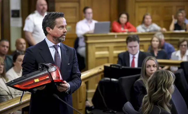 Defense attorney Alan Jackson questions accident reconstruction specialist Dr. Daniel Wolfe while holding a 2021 Lexus SUV taillight assembly during Karen Read's murder trial in Norfolk Superior Court in Dedham, Mass., Friday, June 6, 2025.(Mark Stockwell/The Sun Chronicle via AP, Pool)