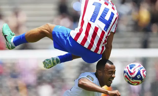 Botafogo's Marlon Freitas, bottom, heads a ball next to Atletico Madrid's Marcos Llorente during the Club World Cup Group B soccer match between Atletico Madrid and Botafogo in Pasadena, Calif., Monday, June 23, 2025. (AP Photo/Jae Hong)