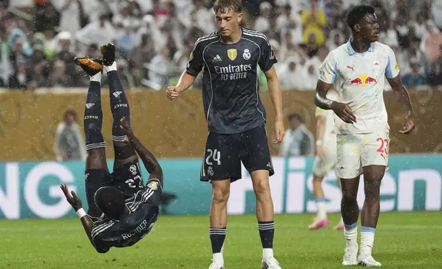 Real Madrid's Antonio Rudiger falls as teammate Real Madrid's Dean Huijsen watches during the Club World Cup Group H soccer match between Salzburg and Real Madrid in Philadelphia, Thursday, June 26, 2025. (AP Photo/Matt Slocum)