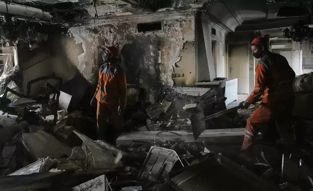 Workers clear rubble of a damaged building, in Tehran, Iran, Wednesday, June 25, 2025, after an Israeli strike on early Tuesday. (AP Photo/Vahid Salemi)